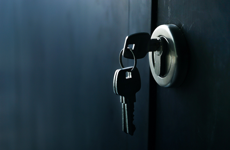Selective focus/Keys stuck in a lock with door.vintage style